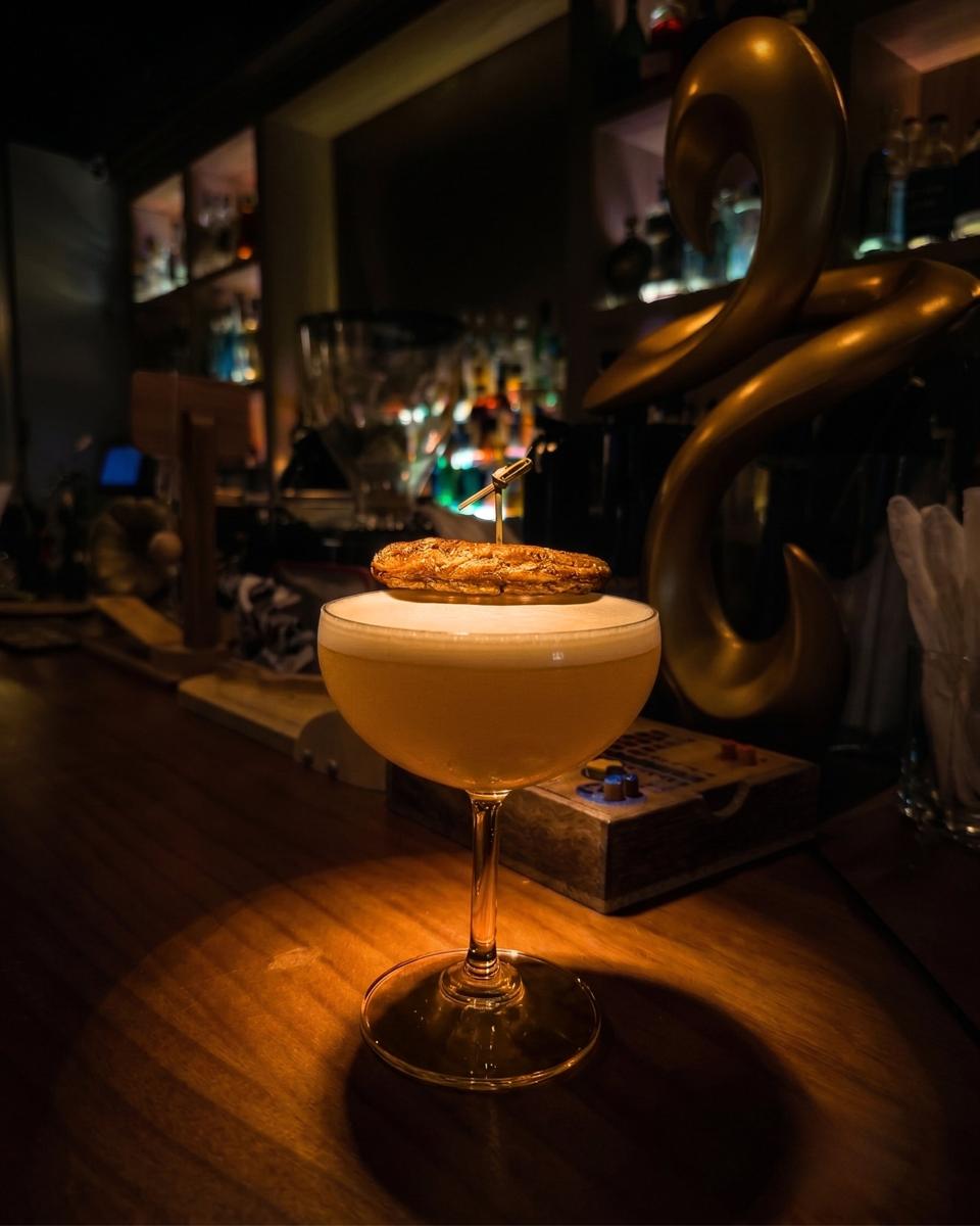 The Banana Pulse in a coupe with a grilled banana garnish