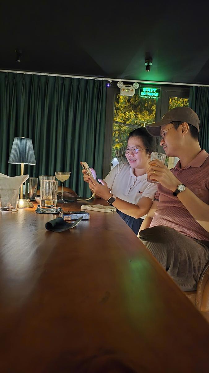Two guests sharing drinks at the long bar